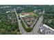 Bird's-eye view of townhomes near a school, nestled between roads with lush green trees and landscaping throughout at 359 Alderwood Ln, Atlanta, GA 30328