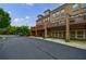 Back exterior view of brick townhomes featuring garage parking and second story decks at 359 Alderwood Ln, Atlanta, GA 30328