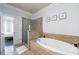 A luxurious bathroom featuring a corner shower and soaking tub adjacent to a bedroom through the doorway at 359 Alderwood Ln, Atlanta, GA 30328