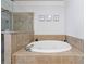 A bright bathroom with a soaking tub and tiled shower for a spa-like experience at 359 Alderwood Ln, Atlanta, GA 30328
