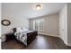 Bedroom with hardwood floors, plantation shutters, and ensuite bathroom access at 359 Alderwood Ln, Atlanta, GA 30328