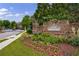 Attractive community sign with brick facade and professionally landscaped flower beds, marking the neighborhood entrance at 359 Alderwood Ln, Atlanta, GA 30328