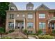 Beautiful townhome exterior with brick facade, dormer windows, and landscaped entryway at 359 Alderwood Ln, Atlanta, GA 30328