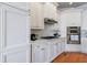 Close up view of white cabinets, stainless steel appliances, marble countertops, and wooden floors at 359 Alderwood Ln, Atlanta, GA 30328