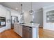 Well-lit kitchen features stainless steel appliances, a center island, and custom white cabinets at 359 Alderwood Ln, Atlanta, GA 30328