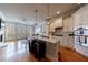 Open concept kitchen with white cabinets, stainless steel appliances, and an island with a marble countertop at 359 Alderwood Ln, Atlanta, GA 30328