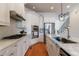 Open concept kitchen with white cabinets, stainless steel appliances, and marble countertops at 359 Alderwood Ln, Atlanta, GA 30328