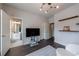 Bright office space with hardwood floors, floating shelves, and a doorway leading to an ensuite bathroom at 359 Alderwood Ln, Atlanta, GA 30328
