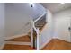 Hardwood staircase with white and black railing leading to the upper level at 359 Alderwood Ln, Atlanta, GA 30328
