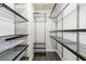Organized walk-in closet with metal shelving, drawers, and hardwood floors at 359 Alderwood Ln, Atlanta, GA 30328