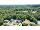 Stunning aerial view showcasing a neighborhood surrounded by dense, green forests at 3740 Duckcove Way, Cumming, GA 30041