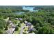 Aerial view showcasing the community, surrounding trees, and lake views at 3740 Duckcove Way, Cumming, GA 30041