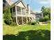 Multi-tiered back porch overlooks green yard, mature plantings, and an in-ground pool, creating a backyard oasis at 3740 Duckcove Way, Cumming, GA 30041