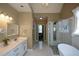 Bright bathroom with a marble-topped vanity, modern fixtures, standing shower, and soaking tub at 3740 Duckcove Way, Cumming, GA 30041