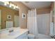 Cozy bathroom with a tub and shower, white sink, and classic fixtures at 3740 Duckcove Way, Cumming, GA 30041