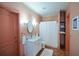 Clean bathroom featuring a single sink vanity, a shower with a curtain, and a built-in linen closet at 3740 Duckcove Way, Cumming, GA 30041