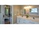 Bright bathroom with double marble-topped vanity and view through sliding barn doors to the main bedroom at 3740 Duckcove Way, Cumming, GA 30041