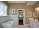 Bright bathroom features a soaking tub, marble tile, and double sink vanity at 3740 Duckcove Way, Cumming, GA 30041