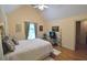 Cozy bedroom featuring a vaulted ceiling, hardwood floors, and ample natural light at 3740 Duckcove Way, Cumming, GA 30041