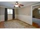 Spacious bedroom with hardwood floors, ceiling fan, and view into another bedroom at 3740 Duckcove Way, Cumming, GA 30041