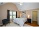 Charming bedroom with vaulted ceiling, hardwood floors, and a comfortable chair at 3740 Duckcove Way, Cumming, GA 30041