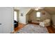 Cozy bedroom featuring hardwood floors, an area rug, a ceiling fan, and dormer windows at 3740 Duckcove Way, Cumming, GA 30041