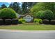 Stone entrance sign for Adams Landing on Lake Lanier, surrounded by manicured landscaping at 3740 Duckcove Way, Cumming, GA 30041