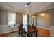 Dining room features natural light, wood floors, decorative trim, and an arched entrance to another room at 3740 Duckcove Way, Cumming, GA 30041