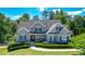 Beautiful two-story home featuring a manicured lawn, colorful shrubbery, and classic architectural details at 3740 Duckcove Way, Cumming, GA 30041