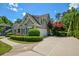 Charming home featuring a manicured lawn, mature trees, a paved driveway, and a two-car garage at 3740 Duckcove Way, Cumming, GA 30041