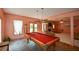 Game room with a full-size billiards table and additional seating area in the background at 3740 Duckcove Way, Cumming, GA 30041
