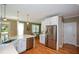 Modern kitchen with stainless steel appliances, white cabinets, and access to outdoor dining at 3740 Duckcove Way, Cumming, GA 30041