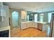 Bright kitchen features white cabinetry, stainless steel appliances, and an island with quartz countertops at 3740 Duckcove Way, Cumming, GA 30041