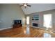 Bright living room featuring a stone fireplace, wood floors, and large windows allowing for an abundance of natural light at 3740 Duckcove Way, Cumming, GA 30041