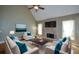 Cozy living room with a stone fireplace, plush seating, and abundant natural light at 3740 Duckcove Way, Cumming, GA 30041