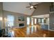 Open living room features a stone fireplace, hardwood floors, and a view of the kitchen with bar seating at 3740 Duckcove Way, Cumming, GA 30041