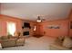 Bright living room featuring a stone fireplace, ceiling fan, and neutral color scheme at 3740 Duckcove Way, Cumming, GA 30041