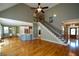 Spacious living room with staircase, hardwood floors, and an open layout at 3740 Duckcove Way, Cumming, GA 30041