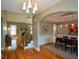 Open-concept living room featuring a stone fireplace and dining area at 3740 Duckcove Way, Cumming, GA 30041
