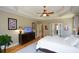 Spacious main bedroom with tray ceiling, wood floors, and a large dresser at 3740 Duckcove Way, Cumming, GA 30041