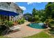 Backyard pool area with a lounge chair, patio, and lush landscaping at 3740 Duckcove Way, Cumming, GA 30041
