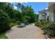 Backyard view showcasing a swimming pool, spa, and stone paver patio with lush landscaping and deck at 3740 Duckcove Way, Cumming, GA 30041