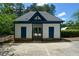 Pool house with white siding, blue trim and a stone base near the pool area at 3740 Duckcove Way, Cumming, GA 30041
