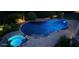 Beautifully lit pool with an adjacent hot tub surrounded by brick pavers and lush landscaping at 3740 Duckcove Way, Cumming, GA 30041