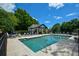 Community pool area with ample seating and umbrellas, perfect for relaxation and social gatherings at 3740 Duckcove Way, Cumming, GA 30041