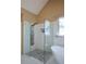 Modern walk-in shower with rainfall shower head, glass enclosure, and pebble flooring at 3740 Duckcove Way, Cumming, GA 30041