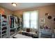 Organized walk-in closet featuring custom shelving, ample storage, and a dressing area with natural light at 3740 Duckcove Way, Cumming, GA 30041