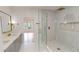 Bright bathroom featuring a glass shower, double sink vanity and marble look wall tiles at 3774 Eli Dr, Snellville, GA 30039