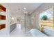 Bright and airy bathroom with a stand alone tub, glass shower, and marble look tiles at 3774 Eli Dr, Snellville, GA 30039