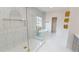 Modern bathroom featuring a glass shower, free-standing tub, and white tile at 3774 Eli Dr, Snellville, GA 30039